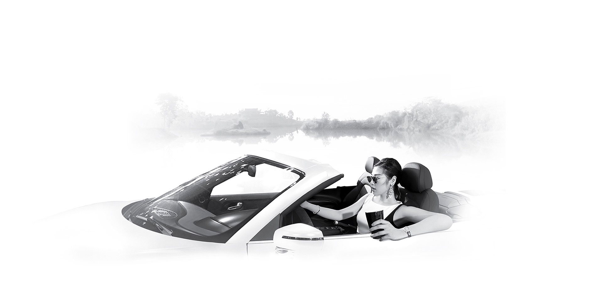 A woman in sunglasses sits in a white convertible holding a dark cup — luxury lifestyle
